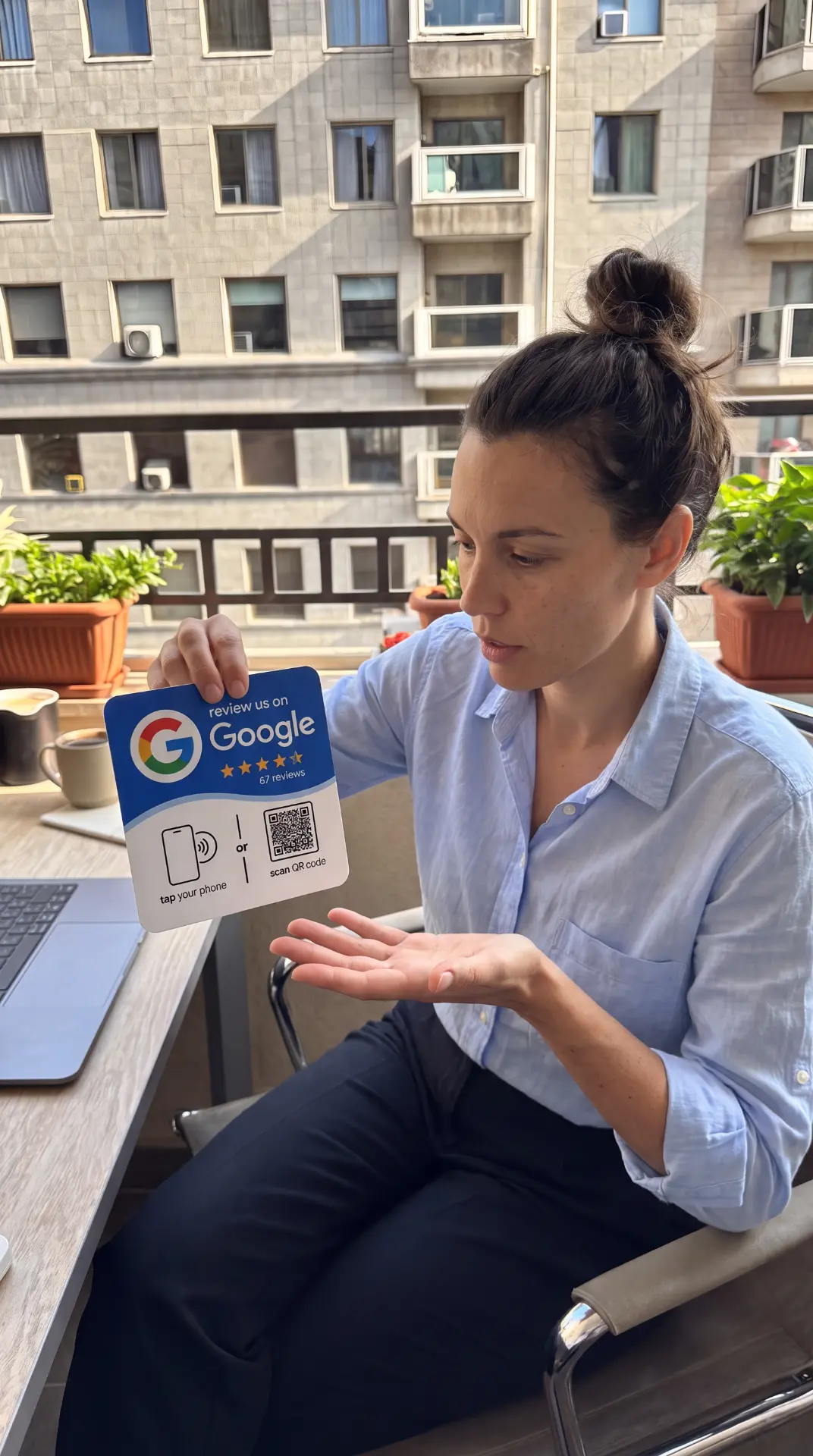 Office worker showing a Google review NFC sign